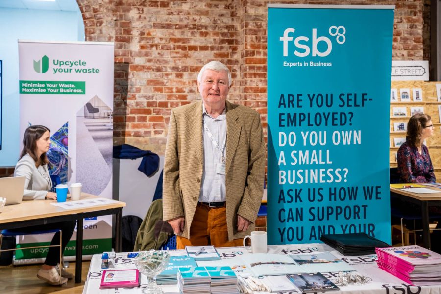 Man on stand at business event
