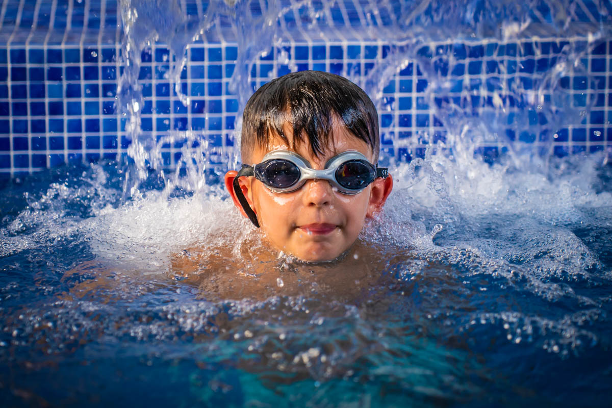 Young boy swimming in goggles