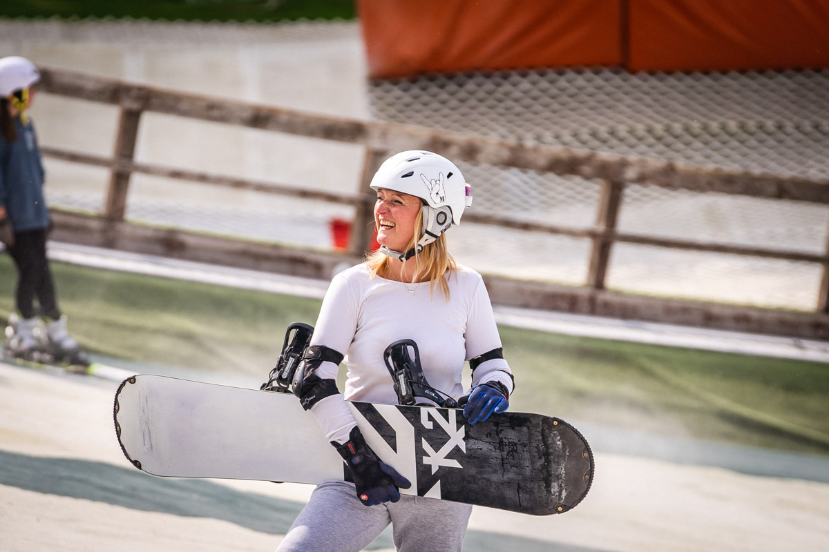Girl holding snow board at ski club