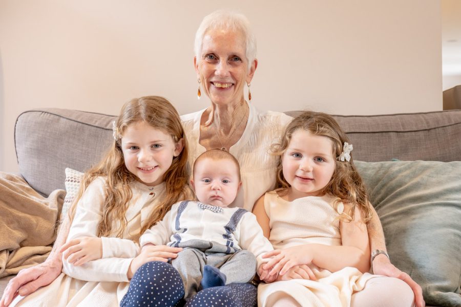 Grandma with grandchildren on sofa