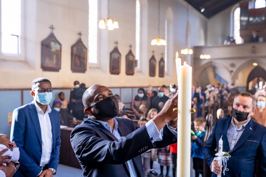 Man lighting candle during chriistening