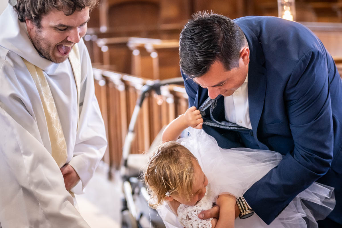 Toddler being christened