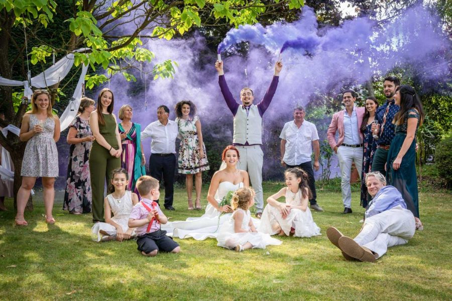 James and Ana wedding party with purple smoke bombs