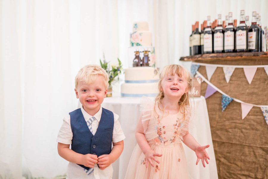 Young guests in front of the cake at Sarah and Dave's wedding